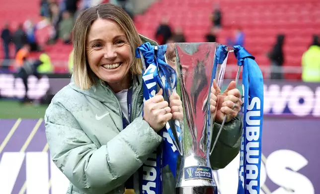 Chelsea manager Sonia Bompastor celebrates with the trophy after winning the Women's League Cup final, in Bristol, England, Sunday, March 15, 2026. (Steve Paston/PA via AP)