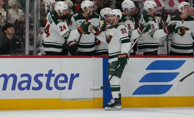 Minnesota Wild right wing Ryan Hartman (38) celebrates his goal against the Chicago Blackhawks during the first period of an NHL hockey game, Tuesday, March, 17, 2026, in Chicago. (AP Photo/David Banks)