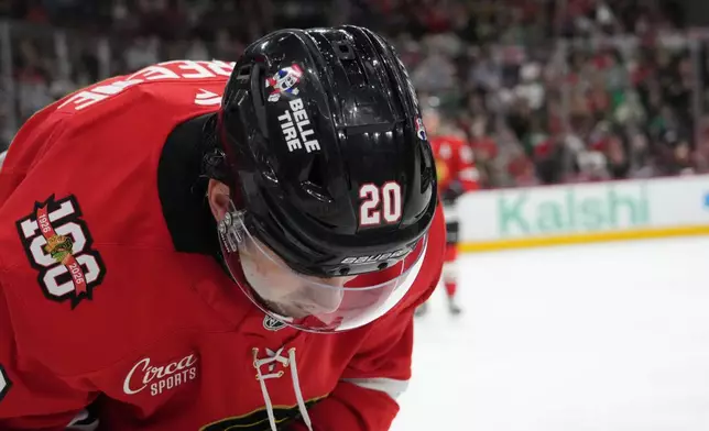 Chicago Blackhawks center Ryan Greene (20) bends over after being struck in the face against the Minnesota Wild during the first period of an NHL hockey game Tuesday, March, 17, 2026, in Chicago. (AP Photo/David Banks)