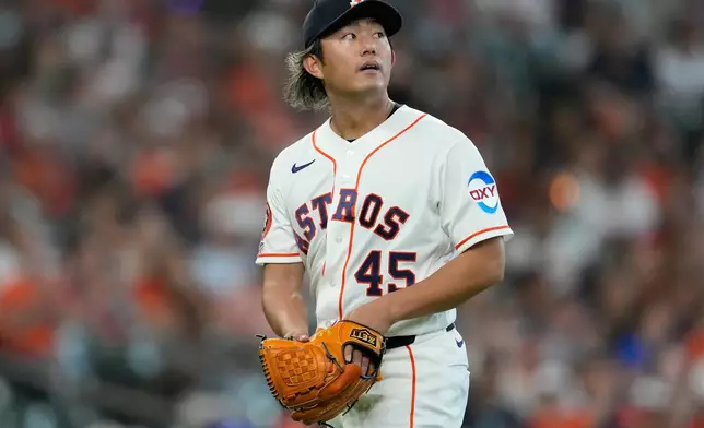 Houston Astros starting pitcher Tatsuya Imai returns to the dugout after the top of the second inning of a baseball game against the Los Angeles Angels in Houston, Sunday, March 29, 2026. (AP Photo/Ashley Landis)