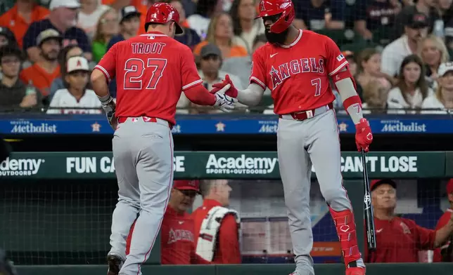 Los Angeles Angels designated hitter Mike Trout celebrates with Jo Adell (7) after scoring during the third inning of a baseball game against the Houston Astros in Houston, Sunday, March 29, 2026. (AP Photo/Ashley Landis)