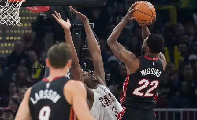 Miami Heat forward Andrew Wiggins (22) shoots over Cleveland Cavaliers center Thomas Bryant (3) in the first half of an NBA basketball game in Cleveland, Wednesday, March 25, 2026. (AP Photo/Sue Ogrocki)