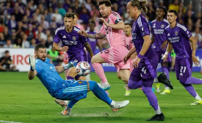 Inter Miami CF forward Lionel Messi, center, goal attempt is stop by Orlando City SC goalkeeper Maxime Crépeau, left, during the first half of an MLS soccer match, Sunday, March 1, 2026, in Orlando, Fla. (AP Photo/Kevin Kolczynski)
