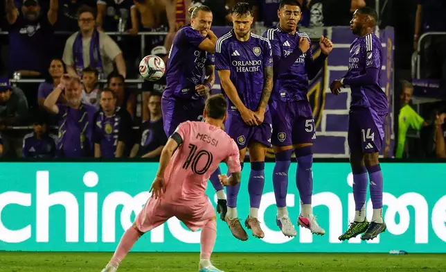 Inter Miami CF forward Lionel Messi (10) takes his penalty kick around Orlando City SC blockers during the second half of an MLS soccer match, Sunday, March 1, 2026, in Orlando, Fla. (AP Photo/Kevin Kolczynski)