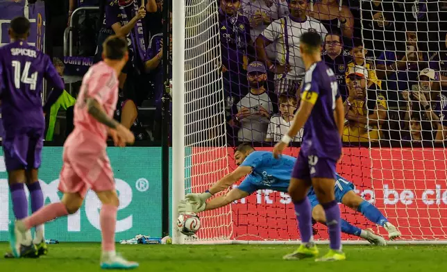 Inter Miami CF forward Lionel Messi, front left, watches as his penalty kick bends into the bottom corner of the goal against Orlando City SC goalkeeper Maxime Crépeau, back right, during the second half of an MLS soccer match, Sunday, March 1, 2026, in Orlando, Fla. (AP Photo/Kevin Kolczynski)