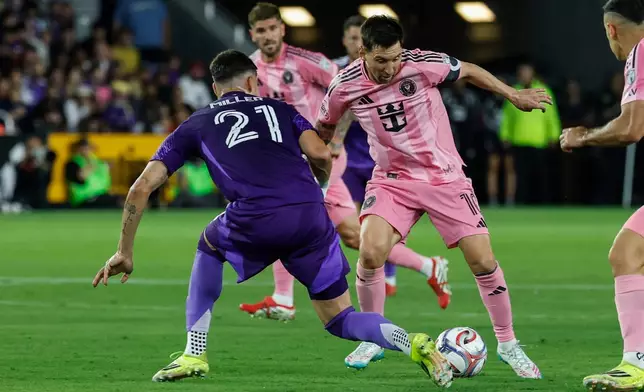 Inter Miami CF forward Lionel Messi, right, controls the ball as he is defended by Orlando City SC defender Nolan Miller (21) during the first half of an MLS soccer match, Sunday, March 1, 2026, in Orlando, Fla. (AP Photo/Kevin Kolczynski)