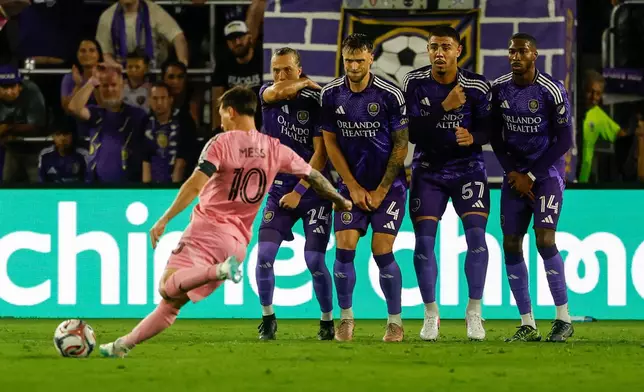 Inter Miami CF forward Lionel Messi (10) takes a penalty kick around Orlando City SC blockers during the second half of an MLS soccer match, Sunday, March 1, 2026, in Orlando, Fla. (AP Photo/Kevin Kolczynski)