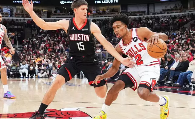 Chicago Bulls guard Collin Sexton (2) drives as Houston Rockets guard Reed Sheppard (15) guards during the first half of an NBA basketball game in Chicago, Monday, March 23, 2026. (AP Photo/Nam Y. Huh)