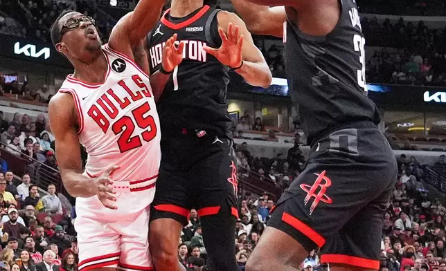 Chicago Bulls forward/center Jalen Smith (25) battles for a rebound against Houston Rockets center Clint Capela, right, and guard Amen Thompson during the first half of an NBA basketball game in Chicago, Monday, March 23, 2026. (AP Photo/Nam Y. Huh)