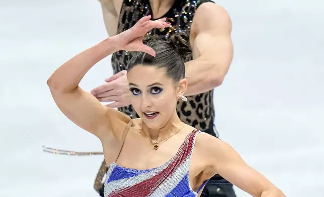 Lilah Fear and Lewis Gibson from Great Britain perform during the ice dance rhythm dance at the Figure Skating World Championships in Prague, Czech Republic, Friday, March 27, 2026. (AP Photo/Petr David Josek)