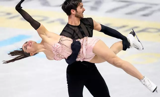 Laurence Fournier Beaudry and Guillaume Cizeron from France perform during the ice dance rhythm dance at the Figure Skating World Championships in Prague, Czech Republic, Friday, March 27, 2026. (AP Photo/Petr David Josek)