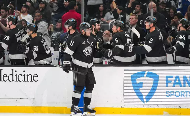 Los Angeles Kings center Anze Kopitar (11) celebrates his goal with teammates during the first period of an NHL hockey game against the Utah Mammoth Saturday, March 28, 2026, in Los Angeles. (AP Photo/Jae C. Hong)