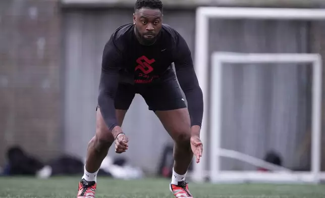 Oluwanifemi 'Neff' Giwa takes part in a football workout session at the National Sports Center, Crystal Palace in London, Sunday, March 29, 2026. (AP Photo/Alastair Grant)