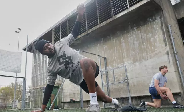Oluwanifemi 'Neff' Giwa, front, takes part in a football workout session at the National Sports Center, Crystal Palace in London, Sunday, March 29, 2026. (AP Photo/Alastair Grant)