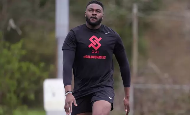 Oluwanifemi 'Neff' Giwa takes part in a football workout session at the National Sports Center, Crystal Palace in London, Sunday, March 29, 2026. (AP Photo/Alastair Grant)