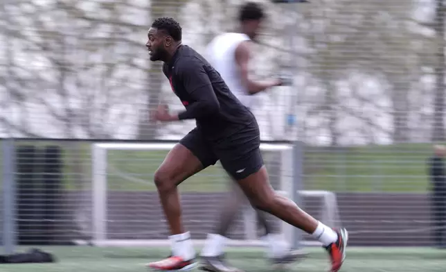 Oluwanifemi 'Neff' Giwa takes part in a football workout session at the National Sports Center, Crystal Palace in London, Sunday, March 29, 2026. (AP Photo/Alastair Grant)