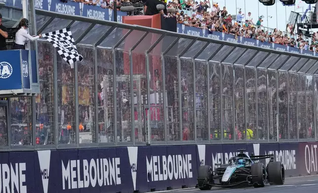 Mercedes driver George Russell of Britain crosses the finish line to win the Australian Formula One Grand Prix at Albert Park, in Melbourne, Australia, Sunday, March 8, 2026. (AP Photo/Heath McKinley)