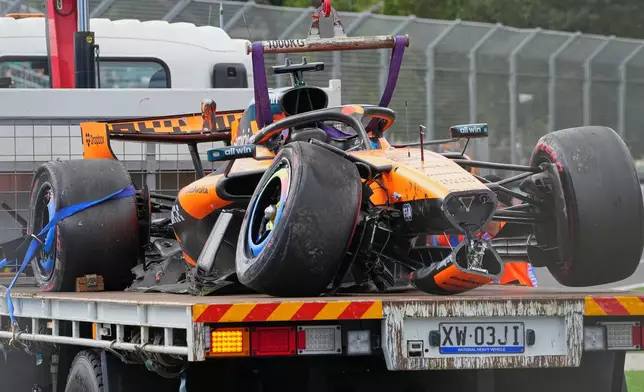 McLaren driver Oscar Piastri of Australia's car is taken from the track track after he crashed during the formation lap ahead of the Australian Formula One Grand Prix at Albert Park, in Melbourne, Australia, Sunday, March 8, 2026. (AP Photo/Scott Barbour)
