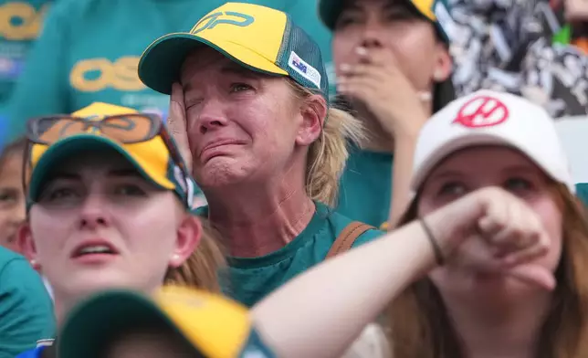 Race fans react ahead of the Australian Formula One Grand Prix at Albert Park, in Melbourne, Australia, Sunday, March 8, 2026. (AP Photo/Asanka Brendon Ratnayake)