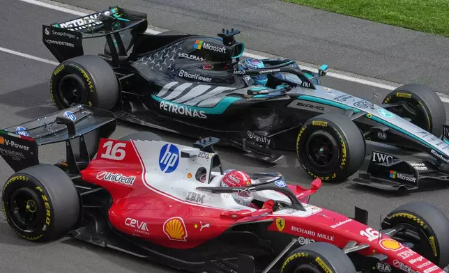 Ferrari driver Charles Leclerc, left, of Monaco passes Mercedes driver George Russell of Britain during the Australian Formula One Grand Prix at Albert Park, in Melbourne, Australia, Sunday, March 8, 2026. (AP Photo/Asanka Brendon Ratnayake)