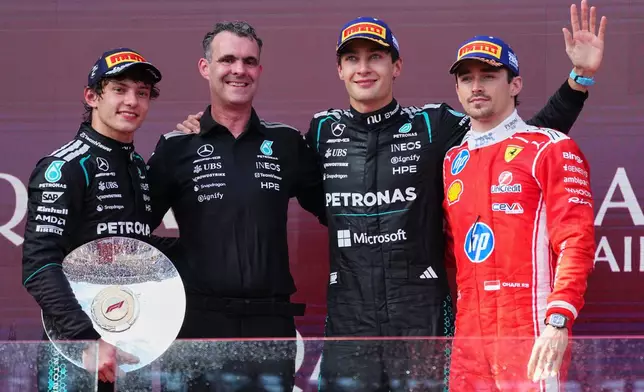 Mercedes driver George Russell of Britain, second right, celebrates with second placed teammate Andrea Kimi Antonelli, left, of Italy and Hywel Thomas, Managing director of Mercedes AMG High Performance Powertrains and third placed Ferrari driver Charles Leclerc, right, of Monaco after winning during the Australian Formula One Grand Prix at Albert Park, in Melbourne, Australia, Sunday, March 8, 2026. (AP Photo/Scott Barbour)