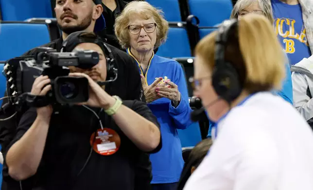 Patti Close watches her daughter, UCLA head coach Cori Close, give a post-game interview after an NCAA college basketball game against Rutgers, Wednesday, Feb. 4, 2026, in Los Angeles. (AP Photo/Caroline Brehman)