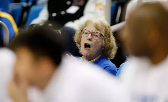 Patti Close, mother of UCLA head coach Cori Close, watches from the stands during the first half of an NCAA college basketball game against Rutgers, Wednesday, Feb. 4, 2026, in Los Angeles. (AP Photo/Caroline Brehman)