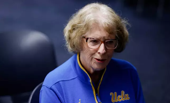 Patti Close, mother of UCLA head coach Cori Close, speaks with a reporter ahead of an NCAA college basketball game against Rutgers, Wednesday, Feb. 4, 2026, in Los Angeles. (AP Photo/Caroline Brehman)