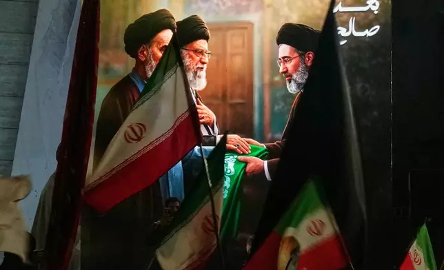 Protesters wave Iranian flags and hold a portrait of the late Iran's Supreme Leader Ayatollah Ali Khamenei and his son Ayatollah Mojtaba Khamenei to support his selection as the new Iran's Supreme Leader in Baghdad, Monday, March 9, 2026. (AP Photo/Hadi Mizban)