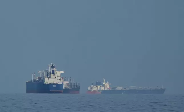 Oil tankers and cargo ships line up in the Strait of Hormuz as seen from Khor Fakkan, United Arab Emirates, Wednesday, March 11, 2026. (AP Photo/Altaf Qadri)