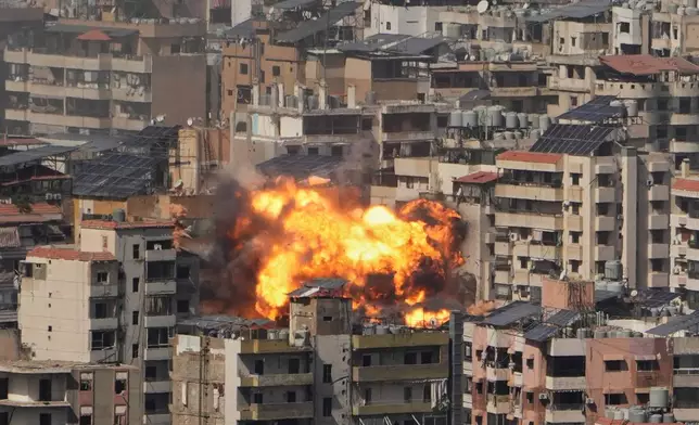 Flames rise from an Israeli airstrike in Dahiyeh, Beirut's southern suburbs, Wednesday, March 11, 2026. (AP Photo/Hassan Ammar)