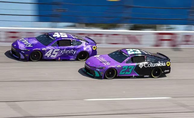 Tyler Reddick (45) and Bubba Wallace (23) compete through Turn 2 during a NASCAR Cup Series auto race, Sunday, March 22, 2026, in Darlington, S.C.(AP Photo/Matt Kelley)