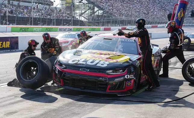 The pit crew for Austin Dillon (3) rushes to complete a pitstop during a NASCAR Cup Series auto race, Sunday, March 22, 2026, in Darlington, S.C.(AP Photo/Matt Kelley)