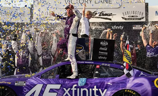 Tyler Reddick, center, celebrates in Victory Lane after winning a NASCAR Cup Series auto race, Sunday, March 22, 2026, in Darlington, S.C.(AP Photo/Matt Kelley)