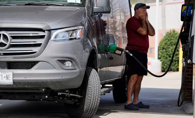 Ray Ruda fills his van with fuel at a gas station Wednesday, March 25, 2026, in Brentwood, Tenn. (AP Photo/George Walker IV)