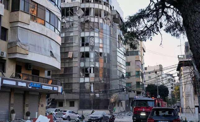 Debris covers a street beside an apartment building hit by an Israeli airstrike in Dahiyeh, Beirut's southern suburb, Lebanon, Monday, March 2, 2026. (AP Photo/Hussein Malla)