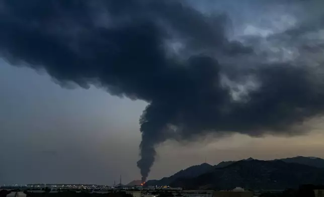 Large fire and plume of smoke is visible after, according to the authorities, debris of an Iranian intercepted drone hit the Fujairah oil facility, in Fujairah, United Arab Emirates, Tuesday, March 3, 2026. (AP Photo/Altaf Qadri)