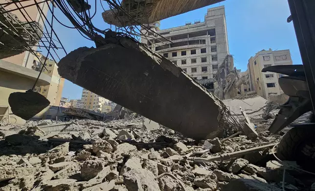 Debris cover the site of Hezbollah’s Al-Manar TV headquarters after it was hit in an Israeli airstrike on Dahiyeh, a southern suburb of Beirut, Lebanon, Tuesday, March 3, 2026. (AP Photo/Hassan Ammar)