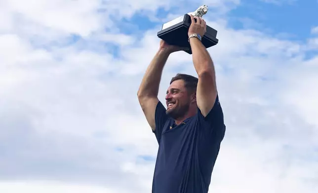 First-place individual champion, captain Bryson DeChambeau, of Crushers GC, poses for a photo with the trophy after the final round of LIV Golf South Africa at The Club at Steyn City, Sunday, March 22, 2026, in Midrand, South Africa. (LIV Golf via AP)
