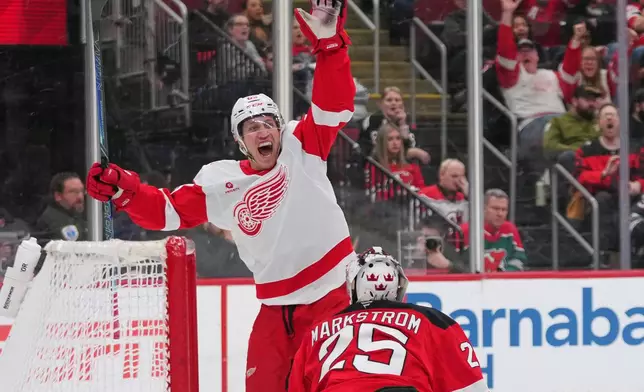 Detroit Red Wings' Dominik Shine (65) celebrates after shooting the puck past New Jersey Devils goaltender Jacob Markstrom (25) for a goal during the third period of an NHL hockey game Sunday, March 8, 2026, in Newark, N.J. (AP Photo/Frank Franklin II)