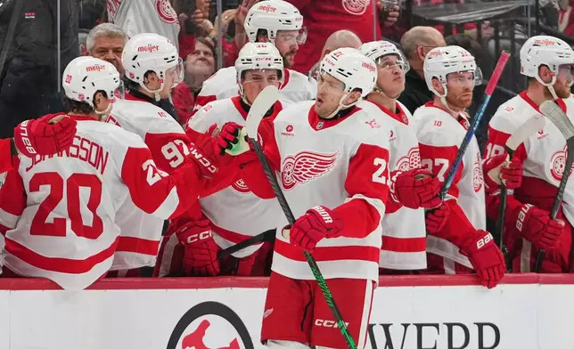 Detroit Red Wings' James van Riemsdyk (21) celebrates with teammates after scoring a goal during the second period of an NHL hockey game against the New Jersey Devils Sunday, March 8, 2026, in Newark, N.J. (AP Photo/Frank Franklin II)