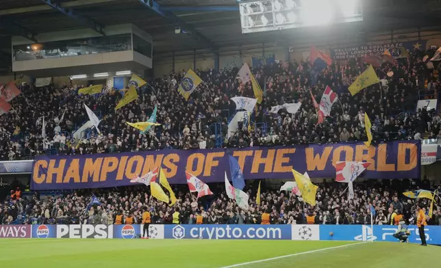 Chelsea fans display a banner reads "Champions of the World" during the Champions League soccer match between Chelsea and Paris Saint-Germain in London, England, Tuesday, March 17, 2026. (AP Photo/Kin Cheung)