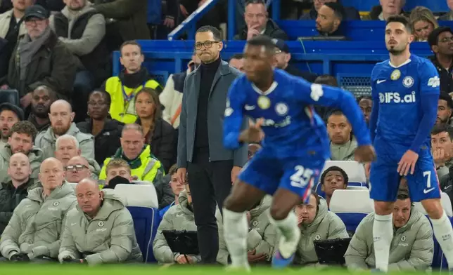 Chelsea's head coach Liam Rosenior, centre, follows the game during the Champions League soccer match between Chelsea and Paris Saint-Germain in London, England, Tuesday, March 17, 2026. (AP Photo/Kin Cheung)