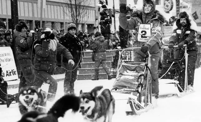 FILE - Susan Butcher races in the Iditarod Trail Sled Dog Race, in Anchorage, Alaska, March 7, 1987. (AP Photo/Rob Stapleton, File)