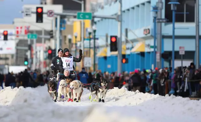 FILE - Michelle Phillips (14), of Canada, mushes down Fourth Street during the Ceremonial Start of the Iditarod Trail Sled Dog Race, in Anchorage, Alaska, March 1, 2025. (AP Photo/Amanda Loman, File)