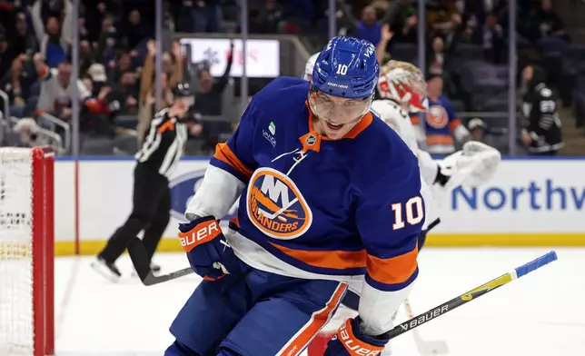 New York Islanders center Brayden Schenn (10) reacts after scoring a goal past Florida Panthers goaltender Daniil Tarasov in the second period of an NHL hockey game Saturday, March 28, 2026, in Elmont, N.Y. (AP Photo/Adam Hunger)