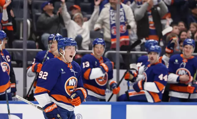 New York Islanders right wing Simon Holmstrom (92) reacts after scoring a goal in the second period of an NHL hockey game against the Florida Panthers, Saturday, March 28, 2026, in Elmont, N.Y. (AP Photo/Adam Hunger)