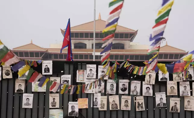 Photos of people who died in last year's deadly anti-corruption Gen Z protest are placed on the gate of the parliament building in Kathmandu, Nepal, Sunday, March 8, 2026. (AP Photo/Niranjan Shrestha)