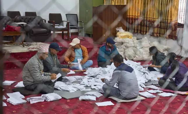 Election official count votes at a counting center for parliamentary election in Lalitpur, Nepal, Sunday, March 8, 2026. (AP Photo/Niranjan Shrestha)