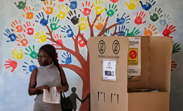 A woman votes during legislative elections in Buenos Aires, Cauca state, Colombia, Sunday, March 8, 2026. (AP Photo/Santiago Saldarriaga)